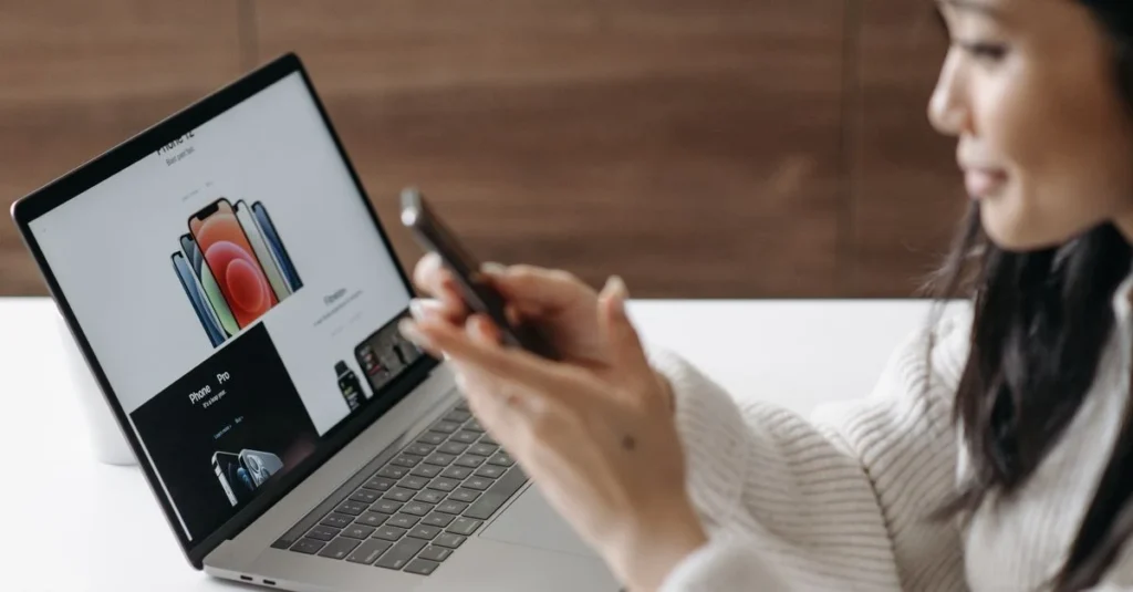 Woman reading Nosto reviews on laptop screen with product personalization interface displayed.